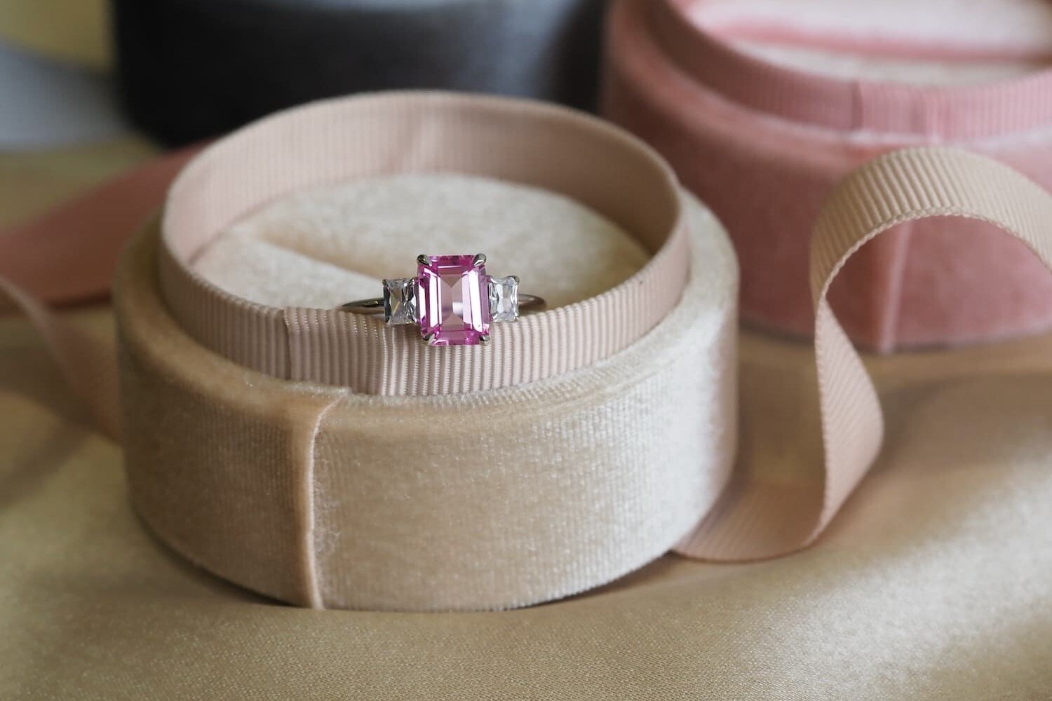 Pink sapphire Emerald cut ring kept in beige box
