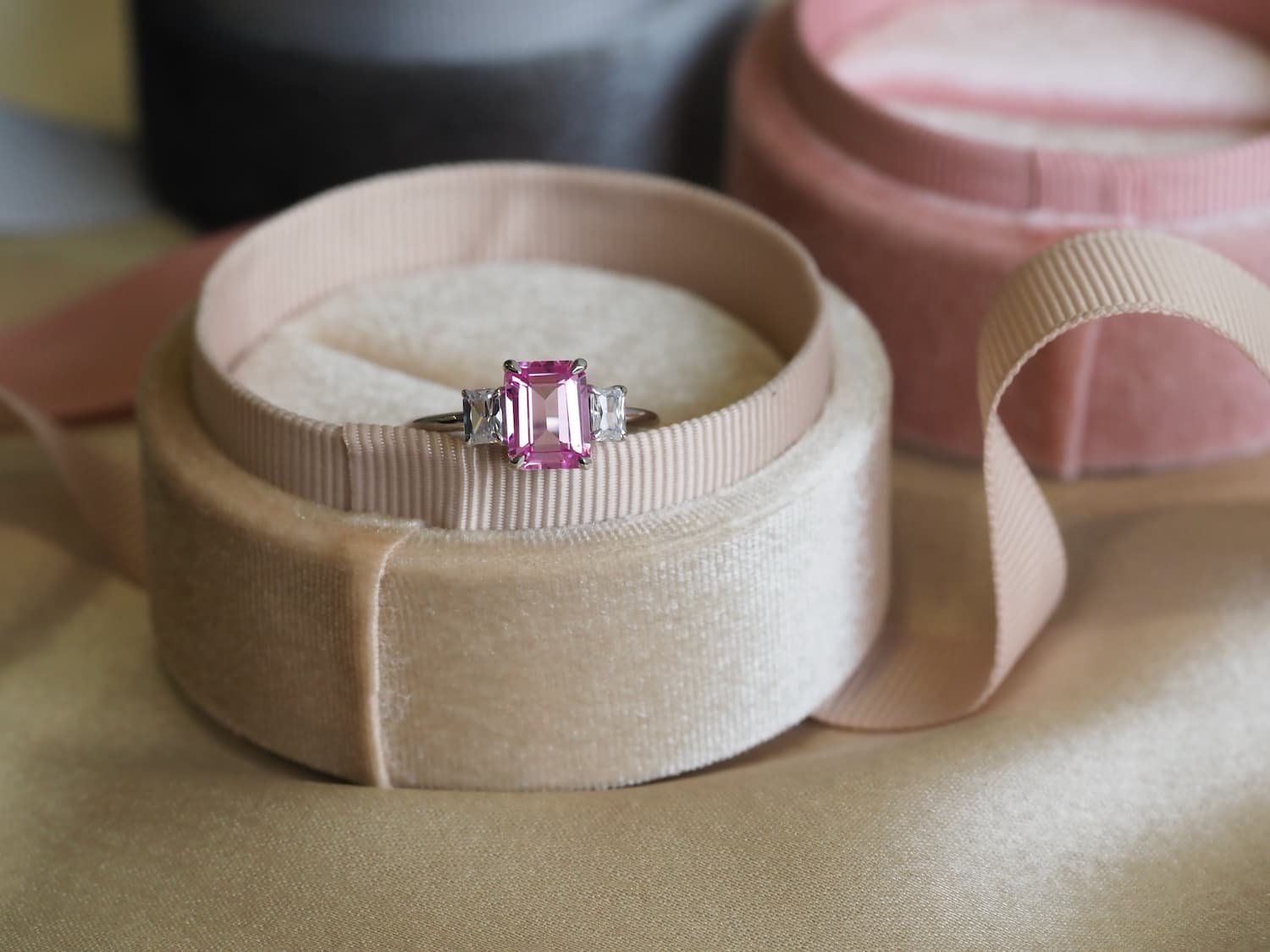 Pink sapphire Emerald cut ring kept in beige box